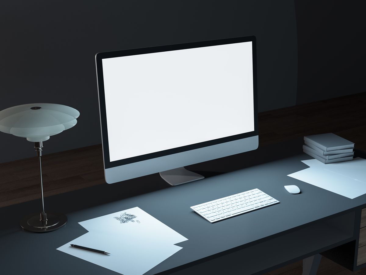 A monitor and desk lamp in a modern studio